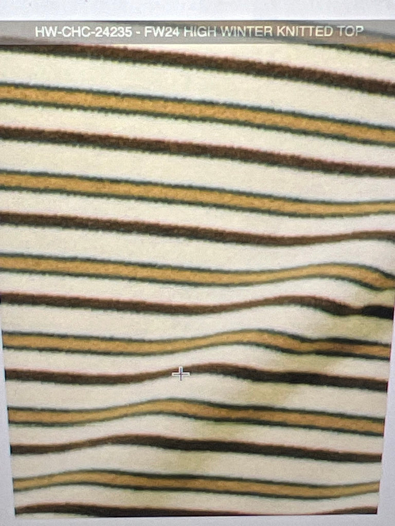 Women’s striped turtleneck long-sleeve top, paired with high-waisted denim jeans, available for sale at an online women’s boutique