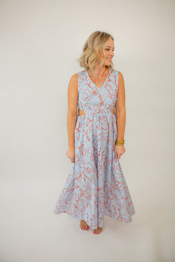 blue_maxi_dress_with_orange_abstract_floral_pring_v-neckline_and_side_ties