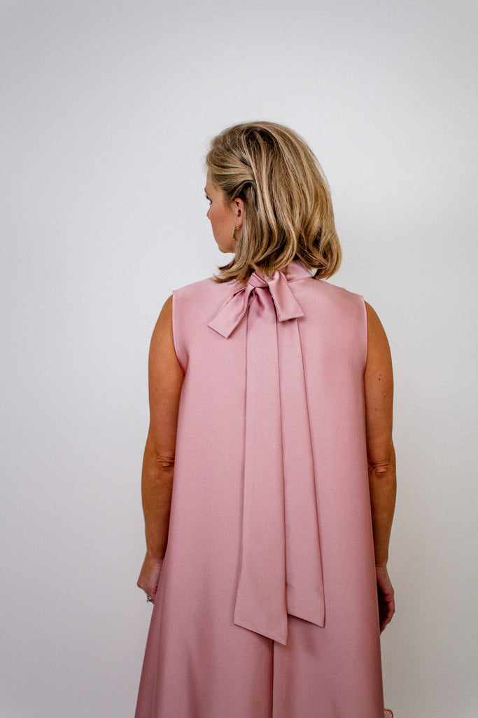 blush pink A-line gown with intricate floral embellishments and a high neckline