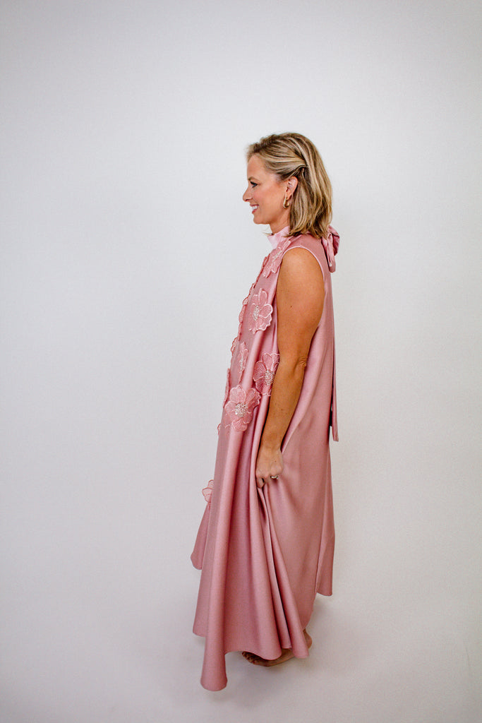 blush pink A-line gown with intricate floral embellishments and a high neckline