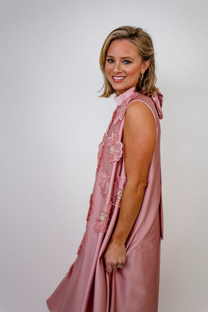 blush pink A-line gown with intricate floral embellishments and a high neckline