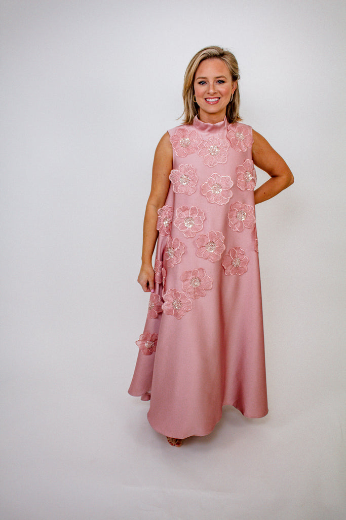 blush pink A-line gown with intricate floral embellishments and a high neckline