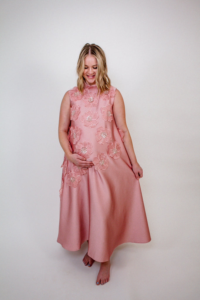 blush pink A-line gown with intricate floral embellishments and a high neckline