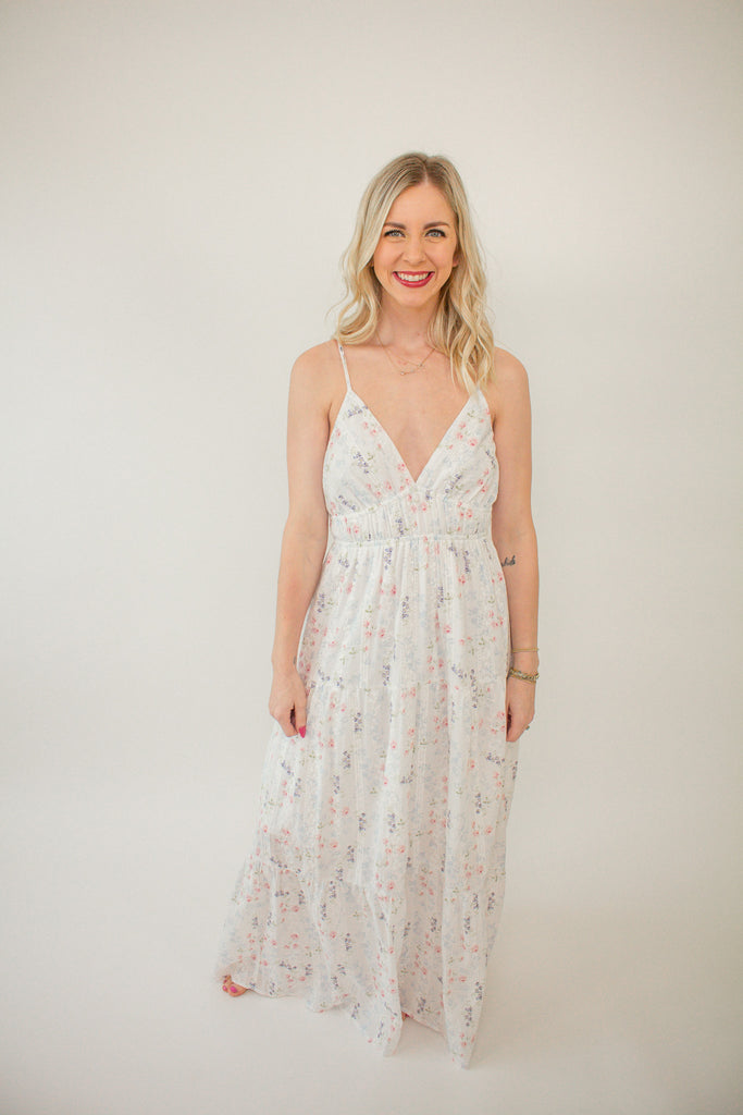 white_floral_maxi_dress_with_a_v-neckline_and_tiered_skirt