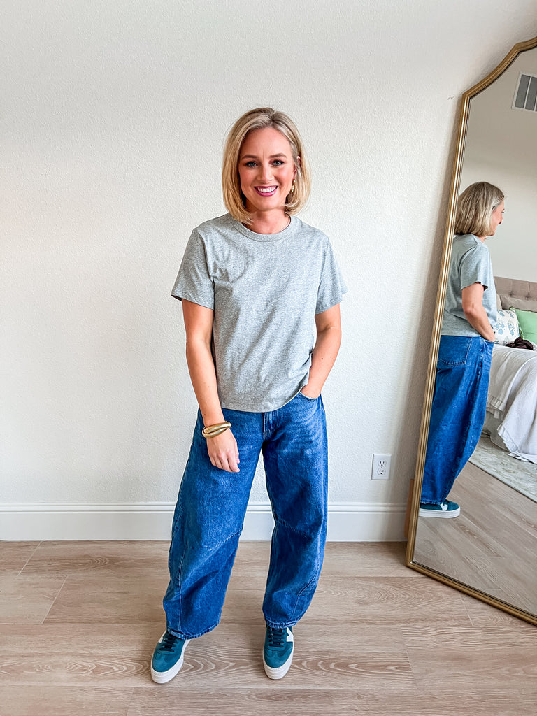 "Heather gray crew neck tee with short sleeves and a relaxed fit, offering a versatile and comfortable style for everyday wear. Perfect for boutique shoppers looking for a classic wardrobe staple."