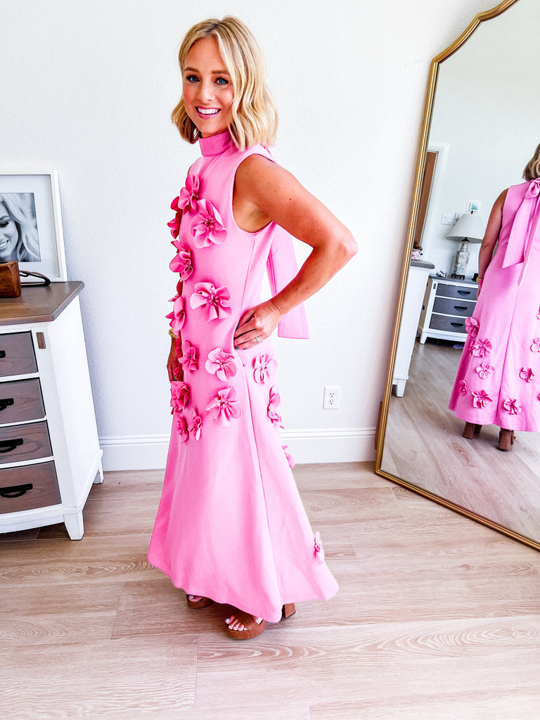 Pink sleeveless maxi dress with 3D floral applique, available for purchase.