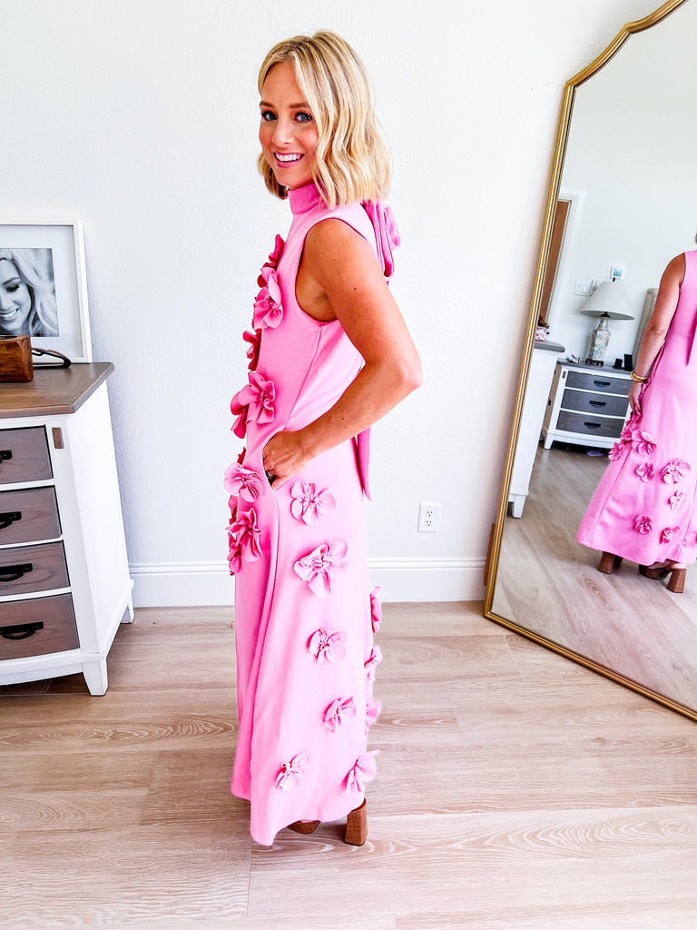 Pink sleeveless maxi dress with 3D floral applique, available for purchase.