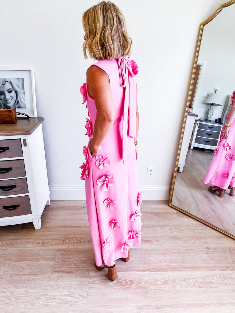 Pink sleeveless maxi dress with 3D floral applique, available for purchase.