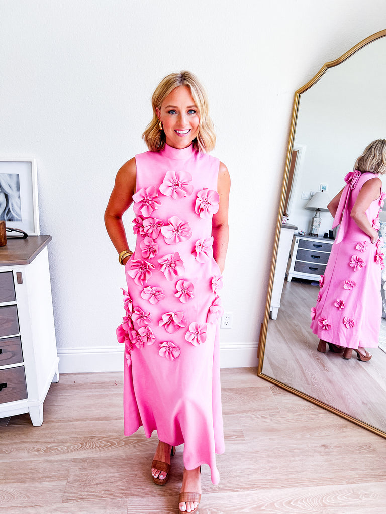 Pink sleeveless maxi dress with 3D floral applique, available for purchase.