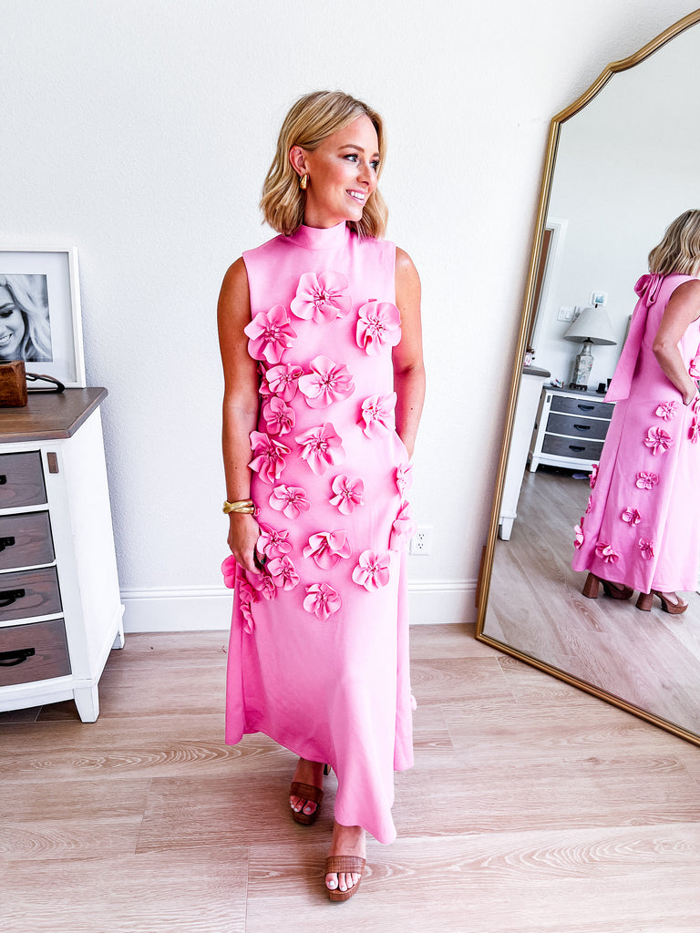 Pink sleeveless maxi dress with 3D floral applique, available for purchase.