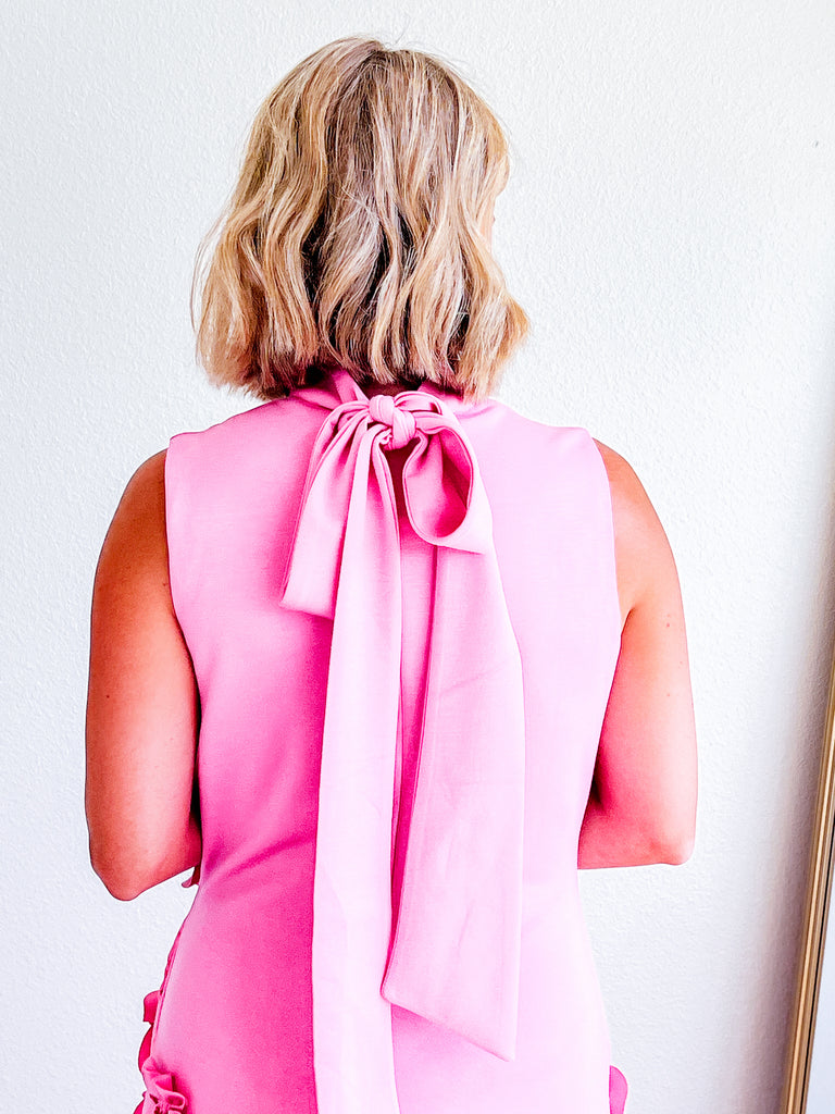 Pink sleeveless maxi dress with 3D floral applique, available for purchase.