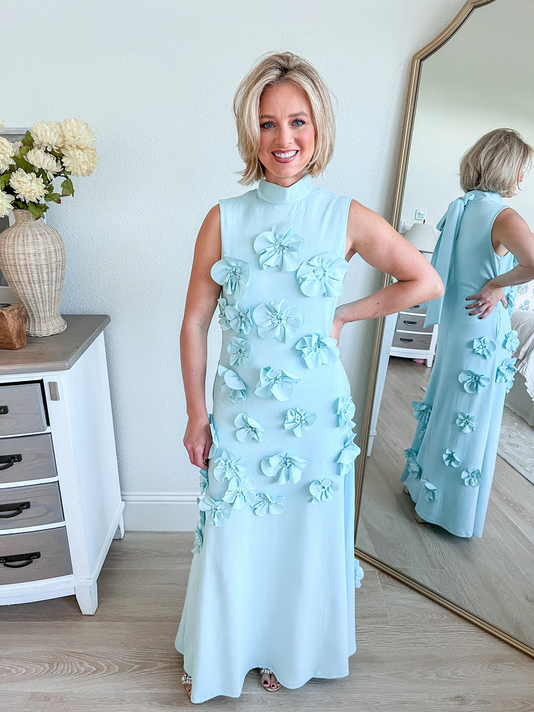 Light Blue sleeveless maxi dress with 3D floral applique, available for purchase.