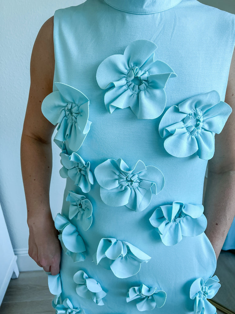 Light Blue sleeveless maxi dress with 3D floral applique, available for purchase.