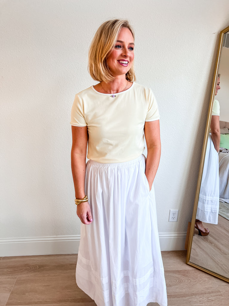 Soft yellow fitted short-sleeve tee with a classic crew neckline, offering a sleek and versatile boutique essential for layering or wearing on its own