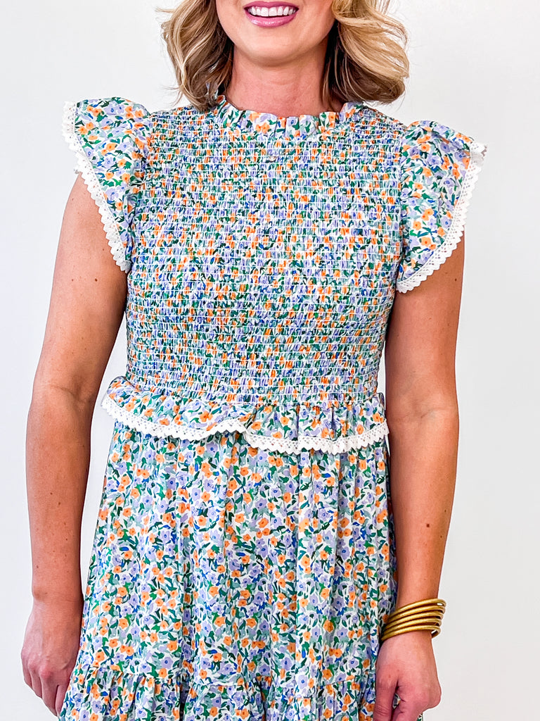 Pastel floral smocked midi dress with flutter sleeves and lace trim
