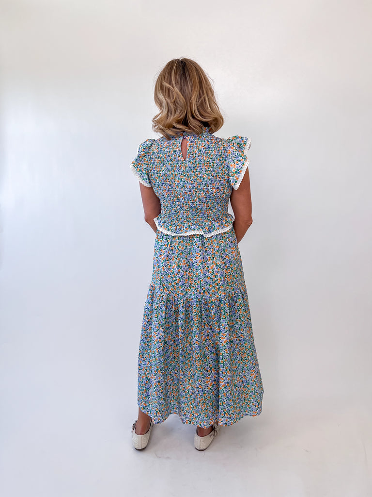 Pastel floral smocked midi dress with flutter sleeves and lace trim