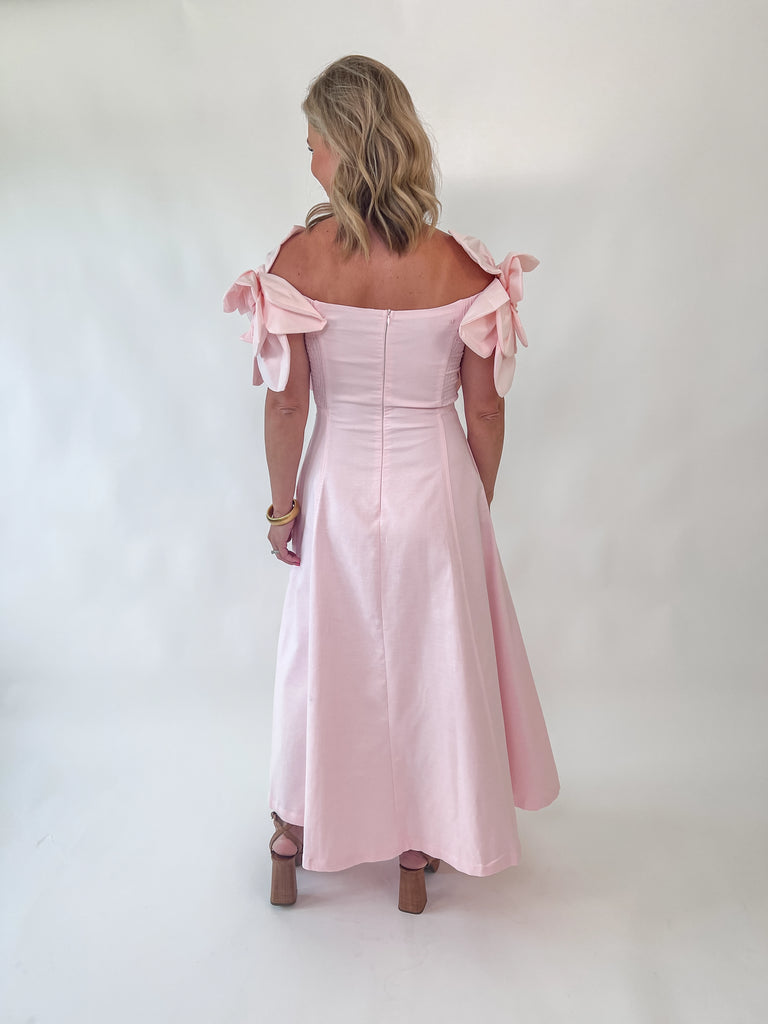 Blush Dress with rosette straps and pleated skirt in a soft pink color