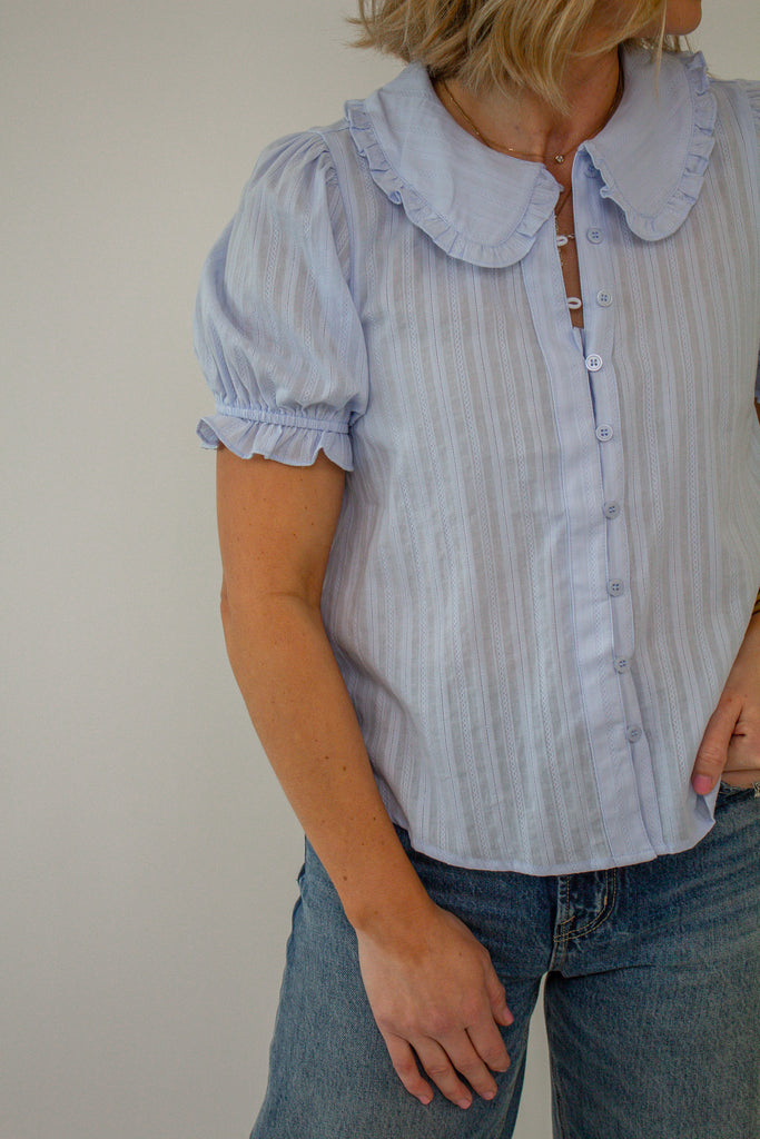 Baby_blue_puff_sleeve_blouse_with_ruffled_collar_and_button_up_front