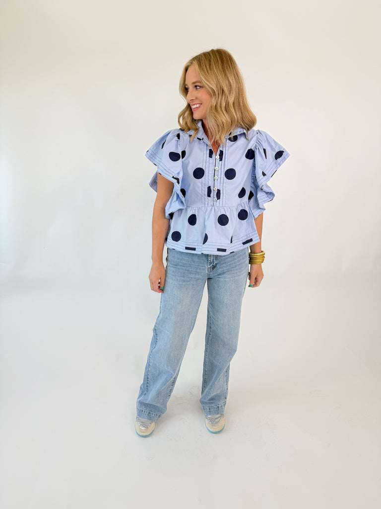 Polka Dot Ruffle Top with flutter sleeves and peplum hem in light blue with navy polka dots