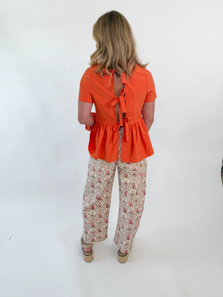 Cream wide-leg pants with rosebud floral embroidery and vintage-inspired pattern