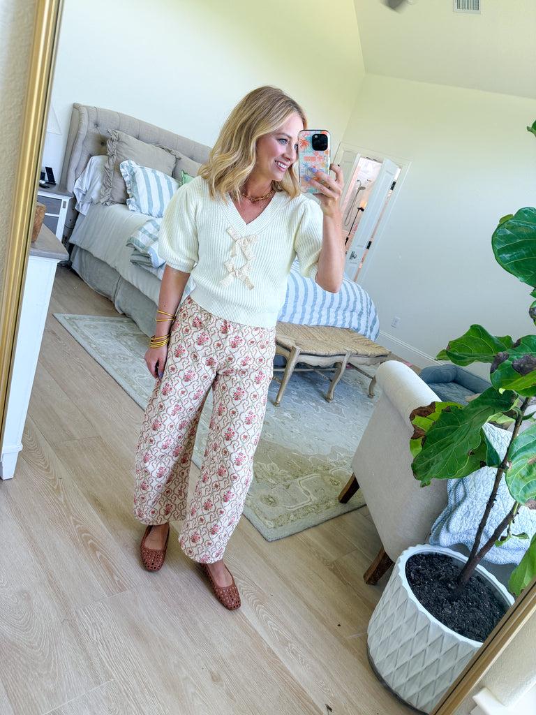 Cream wide-leg pants with rosebud floral embroidery and vintage-inspired pattern