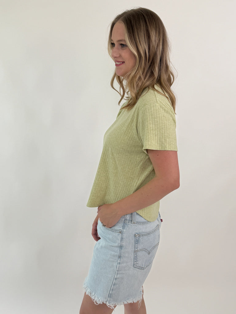 woman wearing short-sleeve ribbed green tee