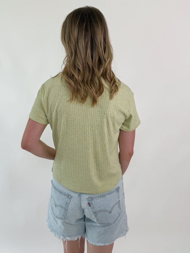 woman wearing short-sleeve ribbed green tee