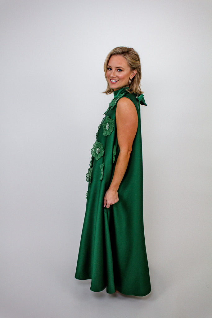 emerald green A-line gown with intricate floral embellishments and a high neckline