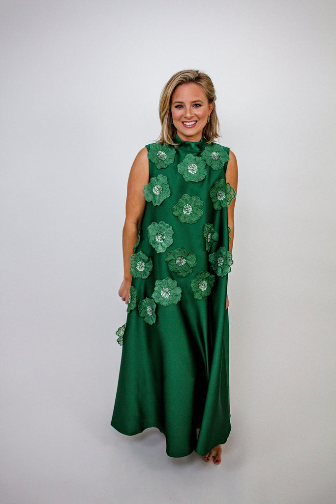 emerald green A-line gown with intricate floral embellishments and a high neckline