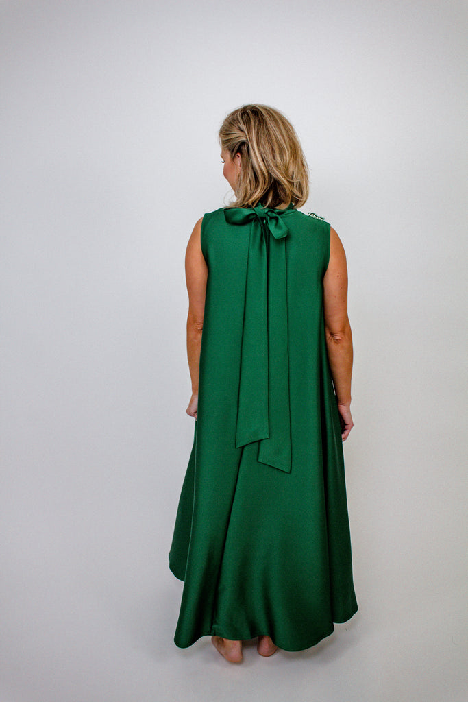 emerald green A-line gown with intricate floral embellishments and a high neckline