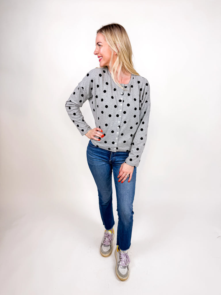 model wearing gray button top with black polka dots