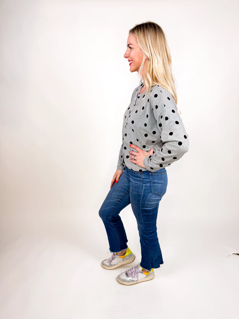 model wearing gray button top with black polka dots