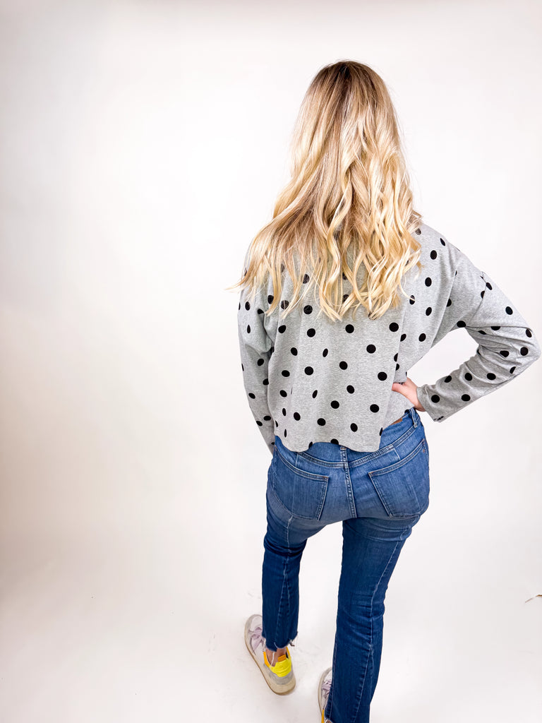 model wearing gray button top with black polka dots