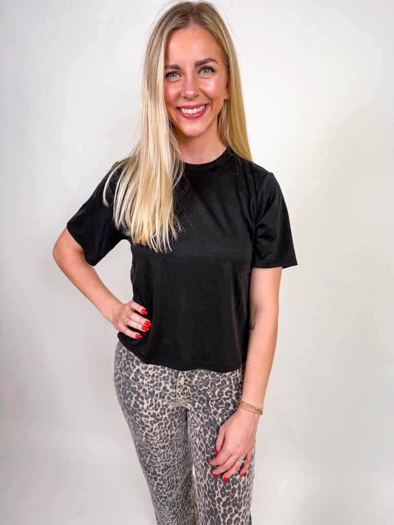 Woman wearing a classic black short sleeve essential tee