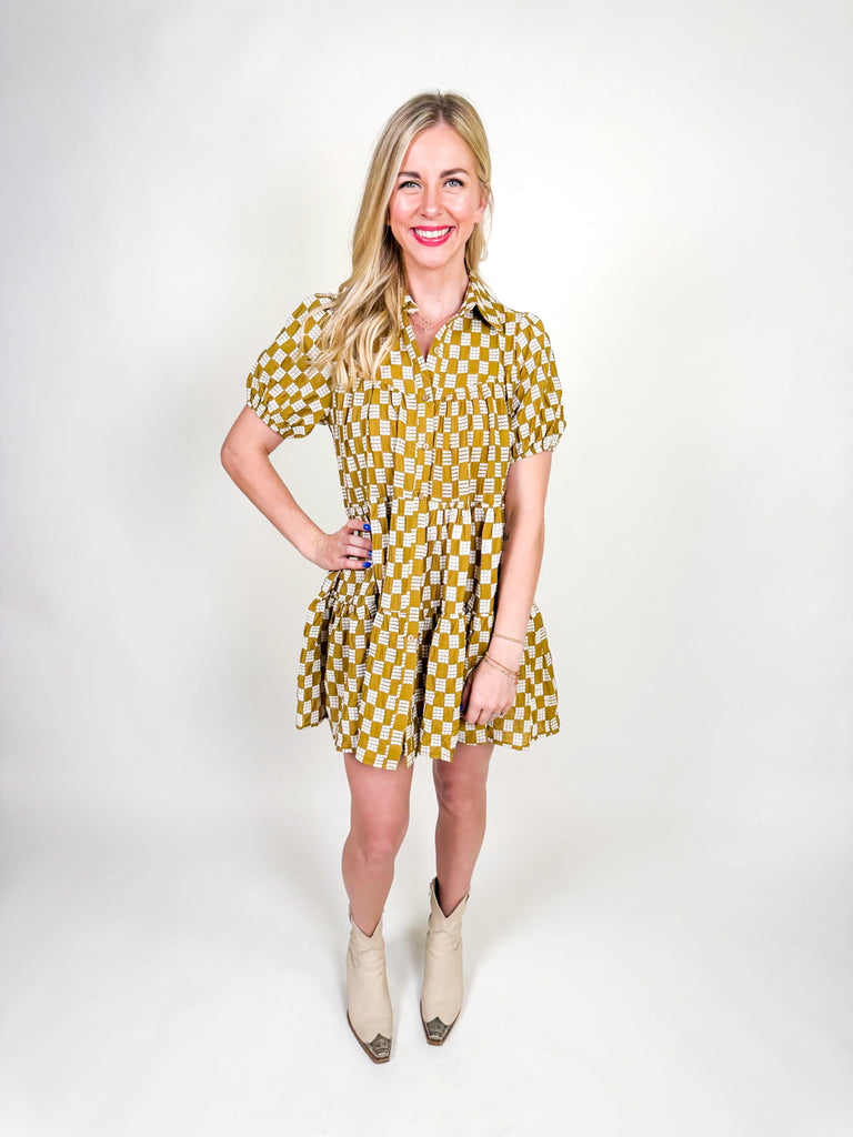 Golden Hour Check Dress in mustard and white check print with short sleeves, collared neckline, and tiered skirt