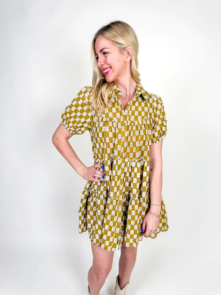 Golden Hour Check Dress in mustard and white check print with short sleeves, collared neckline, and tiered skirt