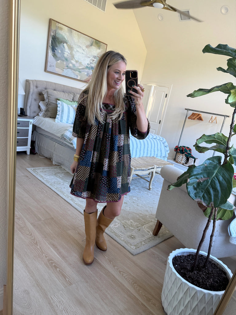 model wearing long sleeve patchwork babydoll dress in earthy floral tones