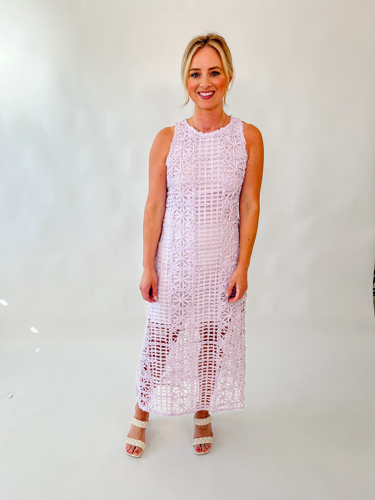Model wearing sleeveless lavender lace midi dress with floral embroidery and sheer hemline