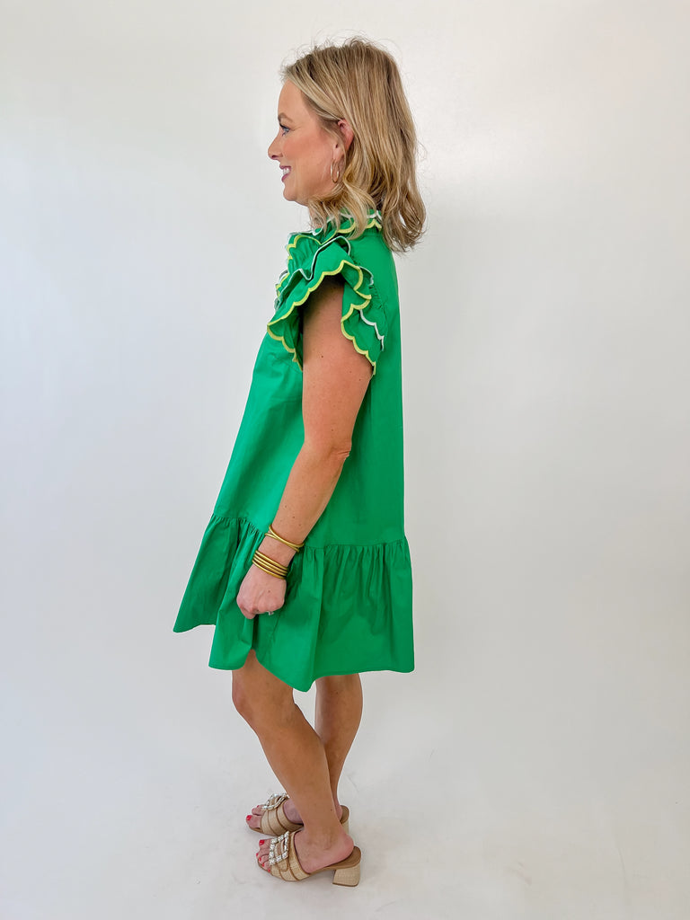 Green mini dress with scalloped flutter sleeves and v-notch neckline