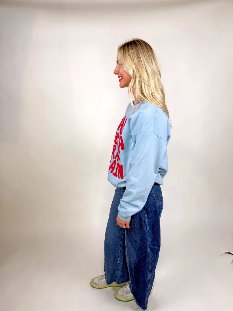 model wearing light blue sweatshirt with red “Make America Pray Again” lettering