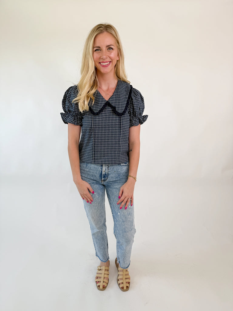 Navy and white checkered short sleeve blouse with oversized ruffle collar and puff sleeves