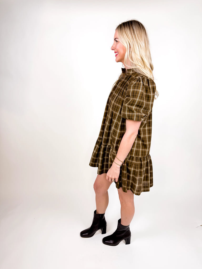 model wearing brown plaid mini dress with puff sleeves and button-front detail