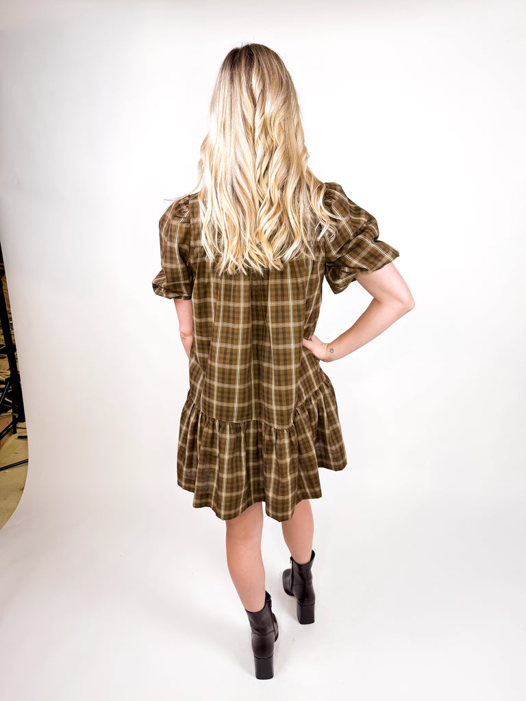 model wearing brown plaid mini dress with puff sleeves and button-front detail