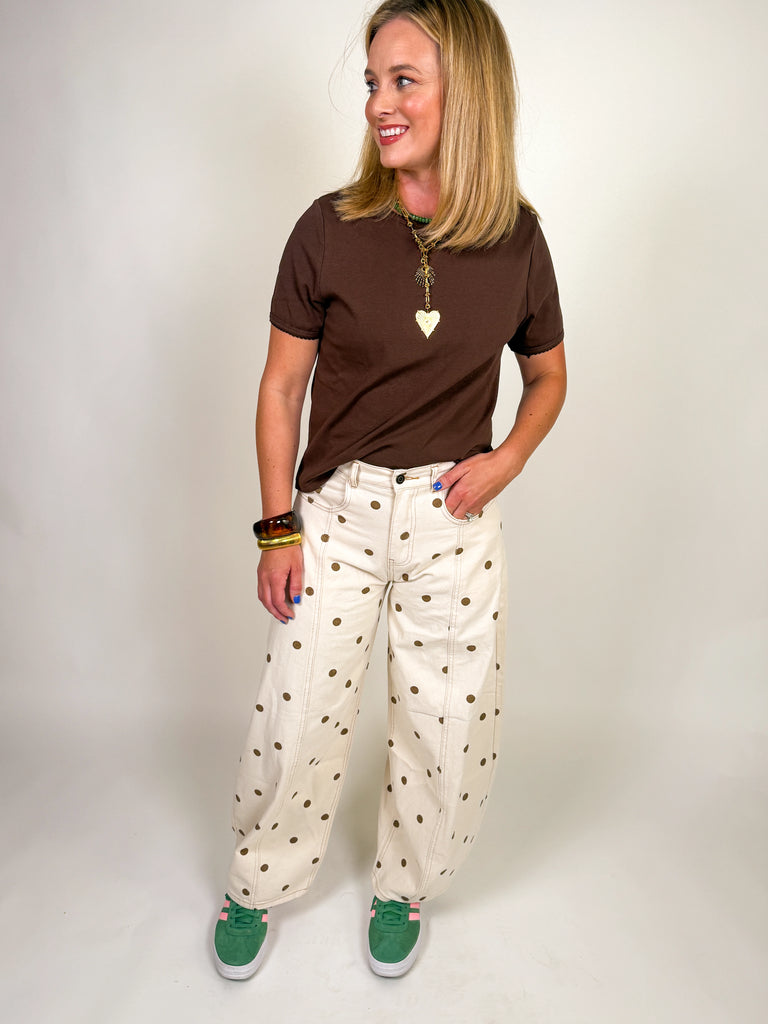 Ivory barrel jeans with allover brown polka dot print styled with a relaxed mid-rise fit