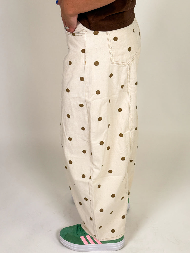 Ivory barrel jeans with allover brown polka dot print styled with a relaxed mid-rise fit