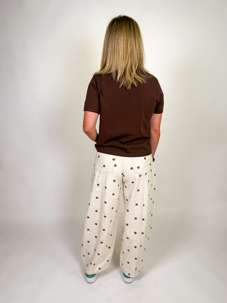 Ivory barrel jeans with allover brown polka dot print styled with a relaxed mid-rise fit