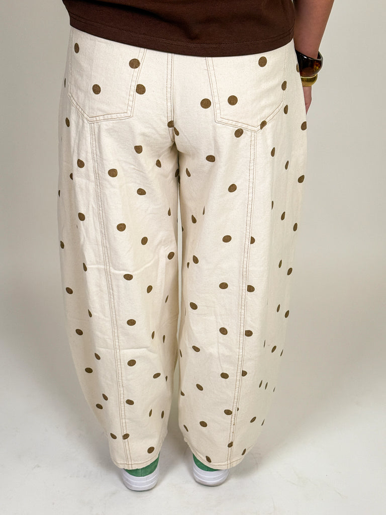 Ivory barrel jeans with allover brown polka dot print styled with a relaxed mid-rise fit