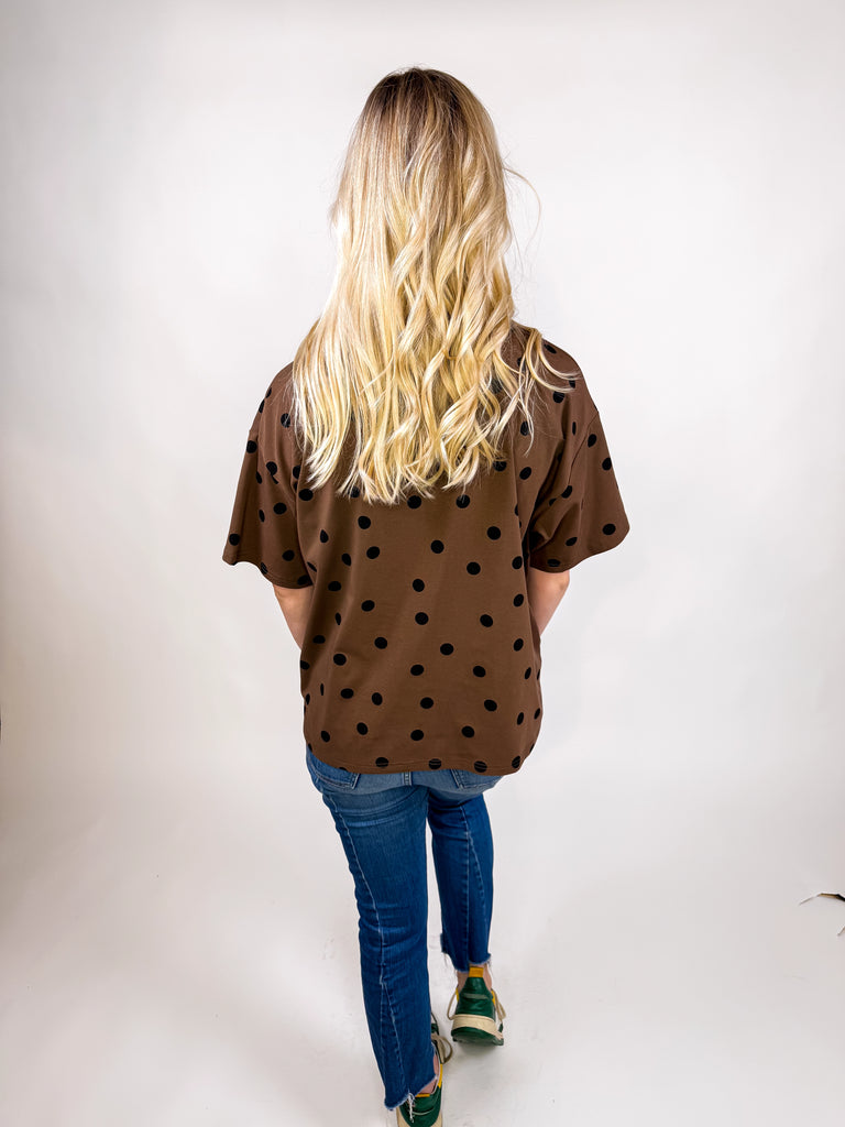 model wearing chocolate brown tee with black polka dots