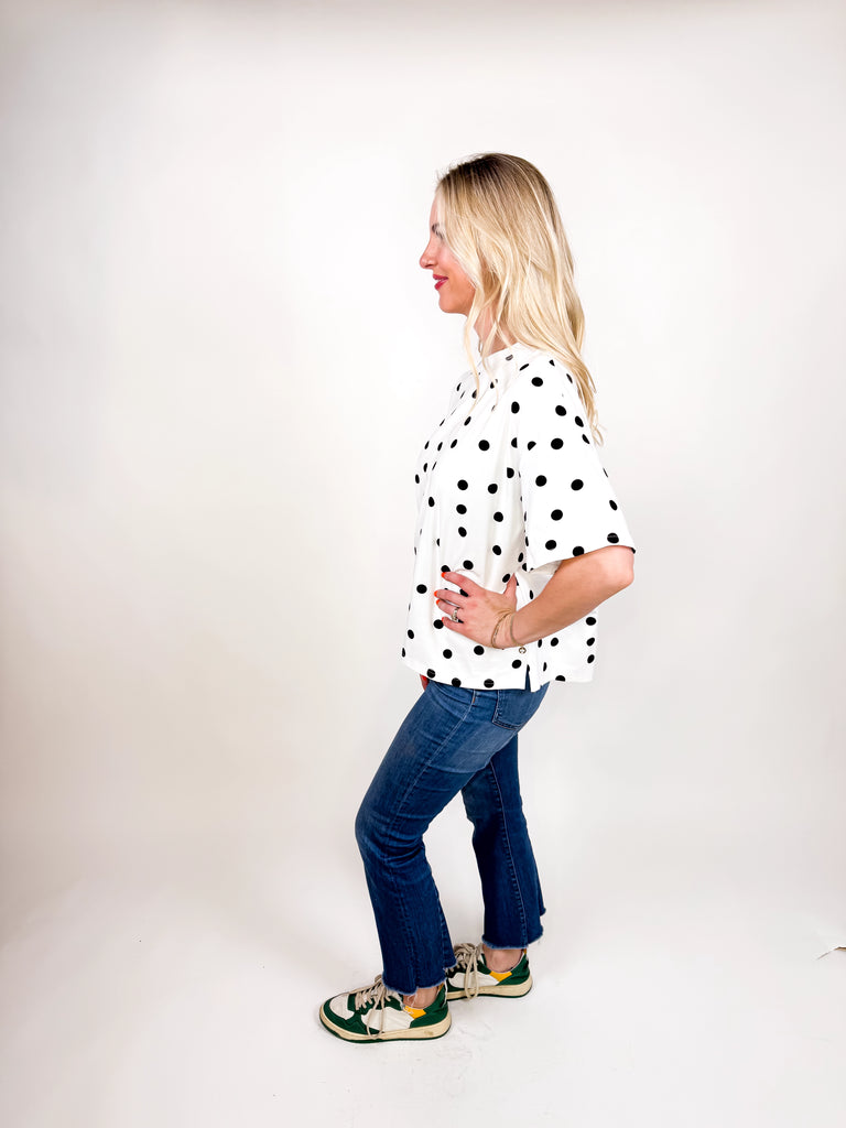 model wearing white tee with black polka dots
