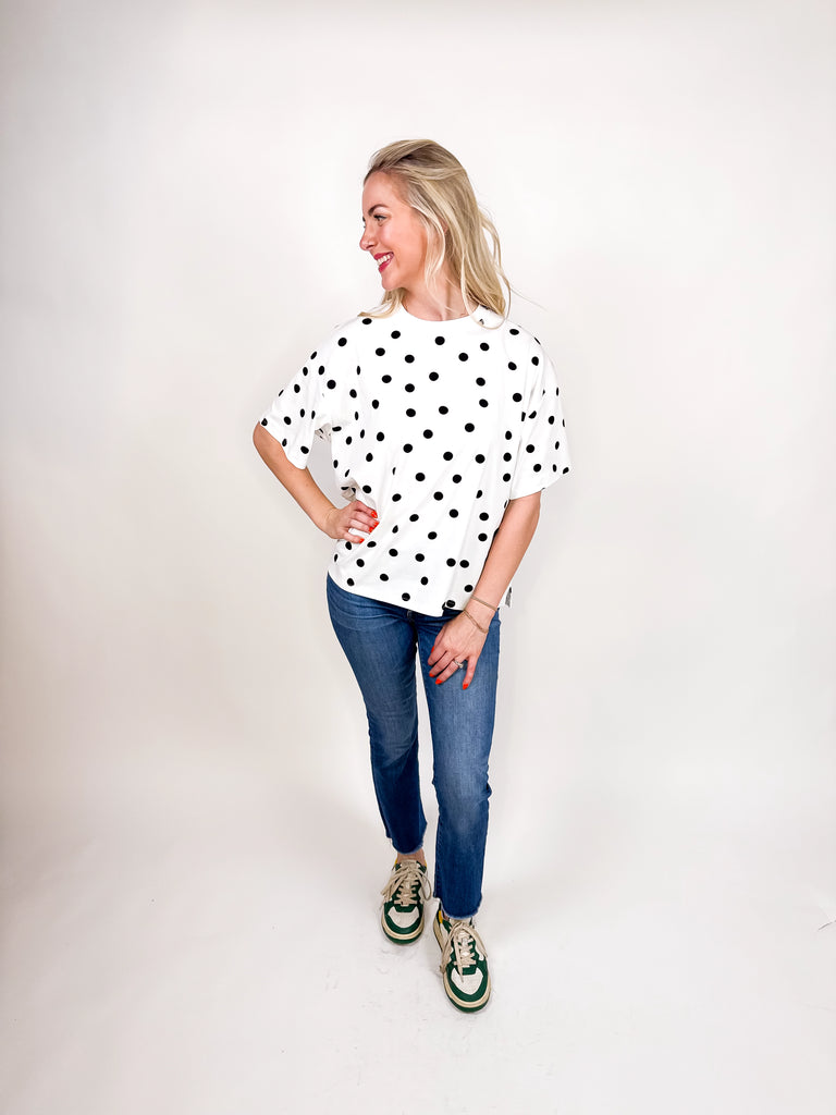 model wearing white tee with black polka dots